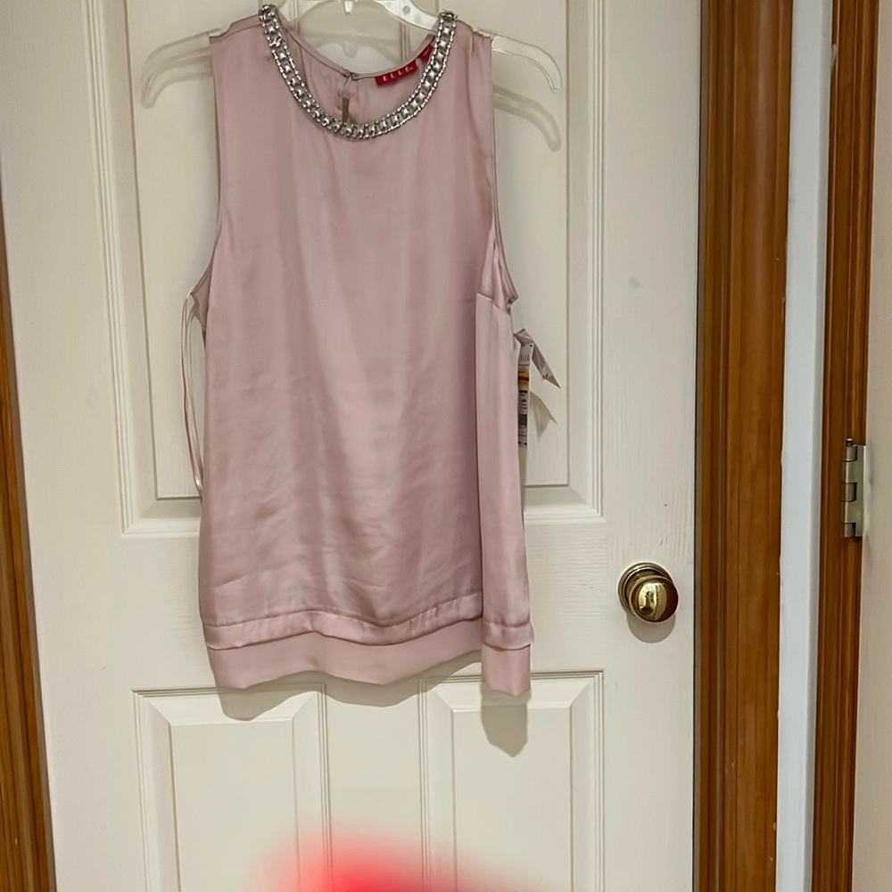 Very dressy rose colored sleeveless top. Detailed rhinestone and pearl neckline